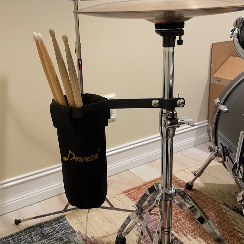 Two sets of drum sticks and holder